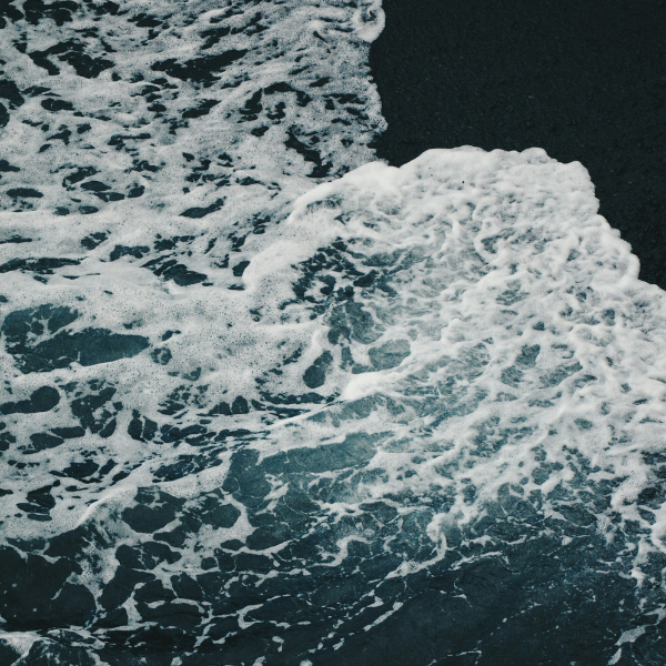 Waves crashing on a black sand beach